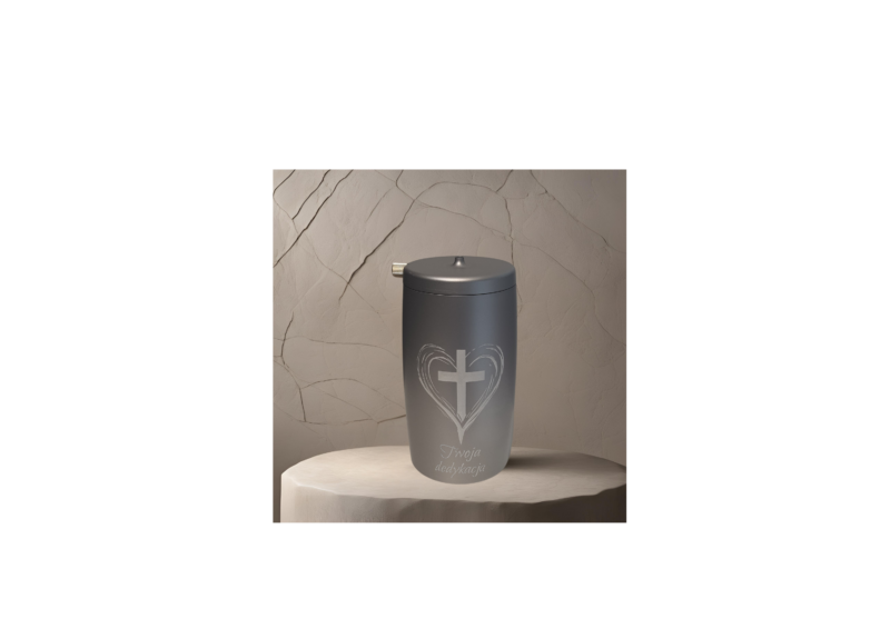 a silver container with a cross and heart and dedication on it